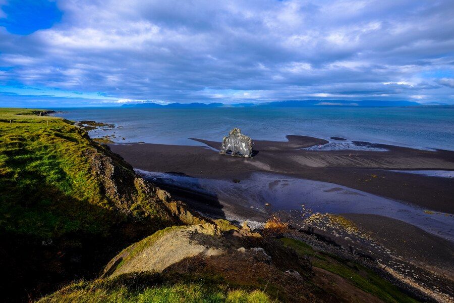 aerial-shot-shoreline-near-grassy-hill-cloudy-sky_181624-3412.jpg